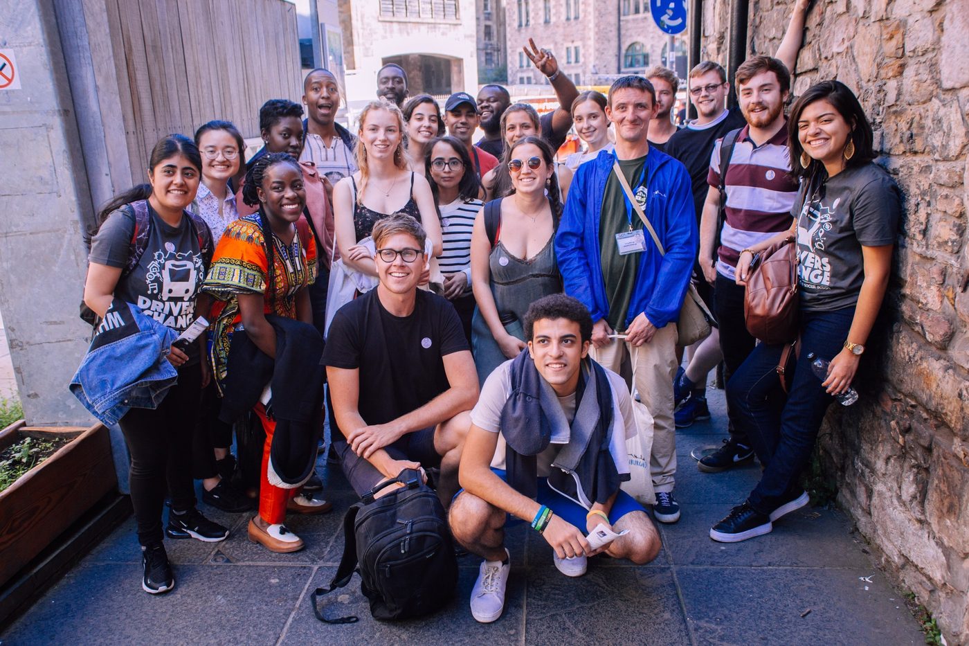 A group of participants in Drivers for Change t-shirts on a city street during the programme